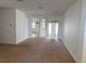An open living area with neutral carpet, freshly painted walls and access to the backyard at 11318 Laurel Brook Ct, Riverview, FL 33569