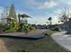 A colorful community playground with slides, climbing structures, and a covered picnic area at 11318 Laurel Brook Ct, Riverview, FL 33569