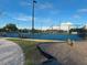 View of the blue tennis and basketball courts with benches and other playground equipment at 11318 Laurel Brook Ct, Riverview, FL 33569