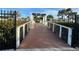 Charming wooden bridge walkway with metal railings and landscaped surroundings at 11318 Laurel Brook Ct, Riverview, FL 33569