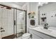 Modern bathroom featuring a glass-enclosed shower with white tile, black accents, and a stylish vanity at 11422 Calusa Trails Way, Riverview, FL 33569