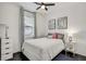 Bright bedroom with dark floors, a comfortable bed, simple decor, and natural light from a window at 11422 Calusa Trails Way, Riverview, FL 33569