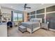 Cozy bedroom with soft carpet, stylish wall decor, and a comfortable bed at 11422 Calusa Trails Way, Riverview, FL 33569