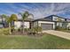 Charming single-story home with a two-car garage, a well-manicured lawn, and attractive landscaping at 11422 Calusa Trails Way, Riverview, FL 33569
