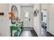 Welcoming foyer with dark wood floors, decorative console table, mirror and stylish decor at 11422 Calusa Trails Way, Riverview, FL 33569