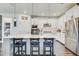 Modern kitchen featuring a large island, white cabinets, and stainless steel appliances at 11422 Calusa Trails Way, Riverview, FL 33569