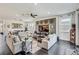 Bright living room featuring dark floors, neutral furniture, and a decorative wall with mounted TV at 11422 Calusa Trails Way, Riverview, FL 33569