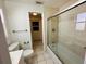 Bathroom featuring tile flooring, glass shower door, and neutral color palette at 12054 145Th St, Largo, FL 33774