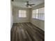 Bedroom with wood-look flooring, ceiling fan, and windows with blinds at 12054 145Th St, Largo, FL 33774