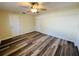 Well-lit bedroom with two doors, new flooring, and overhead ceiling fan at 12054 145Th St, Largo, FL 33774