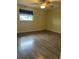 Bedroom featuring wood-look flooring, neutral walls, and a single window at 12054 145Th St, Largo, FL 33774