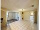 Open dining room with bright neutral tile flooring and laundry room in view at 12054 145Th St, Largo, FL 33774