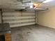 Spacious garage featuring a large garage door and concrete flooring at 12054 145Th St, Largo, FL 33774