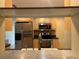 Galley kitchen featuring stainless steel appliances and light wood cabinetry at 12054 145Th St, Largo, FL 33774