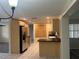 Open-concept kitchen adjacent with stainless steel appliances, ample storage, and modern finishes at 12054 145Th St, Largo, FL 33774