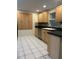 Efficient kitchen features stainless steel appliances, light wood cabinetry, and lots of counter space at 12054 145Th St, Largo, FL 33774