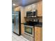 Modern kitchen with stainless steel appliances, light cabinets, and ample countertop space at 12054 145Th St, Largo, FL 33774