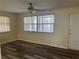 Living room featuring modern wood flooring, ceiling fan, and ample natural light at 12054 145Th St, Largo, FL 33774