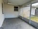 Covered patio area with a screen door, great for enjoying the outdoors at 12054 145Th St, Largo, FL 33774