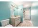 A full bathroom featuring a white vanity, large mirror, and a walk-in shower at 13403 Bolton Ct, Spring Hill, FL 34609