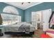 Bedroom features hardwood floors, natural light, and an attached bathroom at 13403 Bolton Ct, Spring Hill, FL 34609