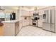 Spacious kitchen features ample countertops, white cabinetry, and stainless steel appliances at 13403 Bolton Ct, Spring Hill, FL 34609