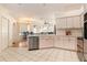 This kitchen features ample countertops, white cabinetry, and stainless steel dishwasher at 13403 Bolton Ct, Spring Hill, FL 34609