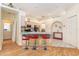 Open kitchen featuring a breakfast bar with red bar stools and stainless steel appliances at 13403 Bolton Ct, Spring Hill, FL 34609