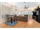 Cozy living space with hardwood floors, a fireplace, and an adjacent dining area at 13403 Bolton Ct, Spring Hill, FL 34609