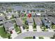 Aerial view of a home in a vibrant neighborhood with a scenic lake and lush green spaces nearby at 17006 Wave Tressle Pl, Wimauma, FL 33598