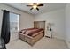 This simple bedroom has light colored furnishings, a window with dark curtains, and neutral colored carpet at 17006 Wave Tressle Pl, Wimauma, FL 33598