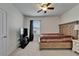 Comfortable bedroom featuring carpet, a ceiling fan, and natural light from a window at 17006 Wave Tressle Pl, Wimauma, FL 33598