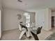Stylish dining area featuring a glass table, modern chairs, and elegant lighting fixture at 17006 Wave Tressle Pl, Wimauma, FL 33598
