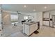 Open-concept living space with an eat in area and kitchen island featuring stainless steel appliances at 17006 Wave Tressle Pl, Wimauma, FL 33598