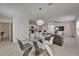 Open-concept living space with dining area and kitchen featuring modern decor and natural light at 17006 Wave Tressle Pl, Wimauma, FL 33598