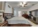This main bedroom boasts warm, neutral colors and a dark wood bedroom suite with a large leather headboard at 17006 Wave Tressle Pl, Wimauma, FL 33598