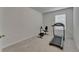 This is a workout room with an exercise bike, treadmill, weights, and a window at 17006 Wave Tressle Pl, Wimauma, FL 33598