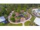 Aerial shot of a community playground, fire pit with Adirondack chairs, and manicured walking trails at 17212 Balance Cv, Land O Lakes, FL 34638