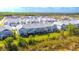 Aerial view showcases the community's townhomes with private, screened patios and verdant landscaping at 17212 Balance Cv, Land O Lakes, FL 34638