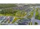 Expansive aerial view of a neighborhood featuring lush green spaces, a playground, and multiple ponds at 17212 Balance Cv, Land O Lakes, FL 34638