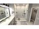 Bright bathroom featuring marble-tiled floor and a spacious walk-in shower with glass door at 17212 Balance Cv, Land O Lakes, FL 34638