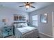 Cozy bedroom features a ceiling fan, comfortable bedding, and complementary decor at 17212 Balance Cv, Land O Lakes, FL 34638