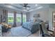 Serene bedroom featuring a plush bed, scenic views from large windows, and stylish decor at 17212 Balance Cv, Land O Lakes, FL 34638