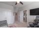 Bright bedroom featuring carpet, ceiling fan, closet, and doorway leading to the Primary bathroom at 17212 Balance Cv, Land O Lakes, FL 34638