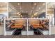 Cafe booth seating with an ornate mirror, wooden tables, and pendant lighting at 17212 Balance Cv, Land O Lakes, FL 34638