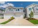 Charming townhomes feature attached garages, gray siding, and well-maintained landscaping for curb appeal at 17212 Balance Cv, Land O Lakes, FL 34638