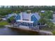 A beautiful waterfront building has a large deck with tables and chairs for residents at 17212 Balance Cv, Land O Lakes, FL 34638