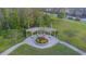 Aerial view of a gazebo in a park surrounded by trees, sidewalks and grass at 17212 Balance Cv, Land O Lakes, FL 34638