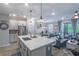 Open kitchen and living room with gray cabinets, stainless steel appliances, and a large center island at 17212 Balance Cv, Land O Lakes, FL 34638