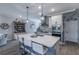 Kitchen with a large island and seating complements stainless steel appliances and white cabinets at 17212 Balance Cv, Land O Lakes, FL 34638